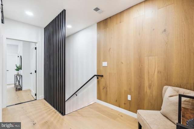 sitting room with an upstairs landing, light wood-type flooring, baseboards, and recessed lighting