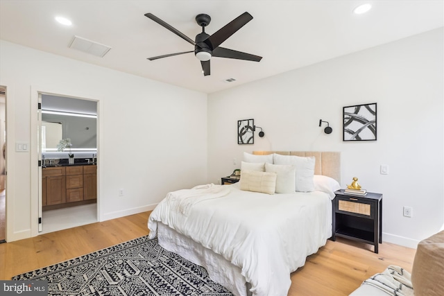 bedroom featuring light wood finished floors, recessed lighting, baseboards, connected bathroom, and ceiling fan