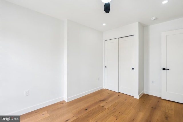 unfurnished bedroom with light wood-type flooring, baseboards, recessed lighting, a closet, and a ceiling fan