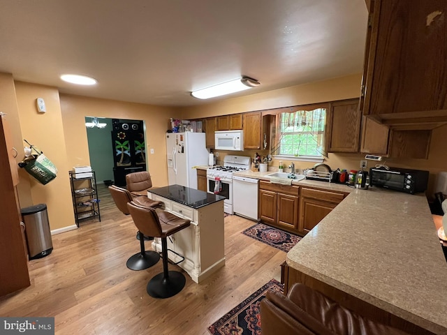 10604 Nast Dr, Cheltenham, MD 20623 - kitchen with a sink, light wood-style floors, a toaster, a kitchen bar, and white appliances