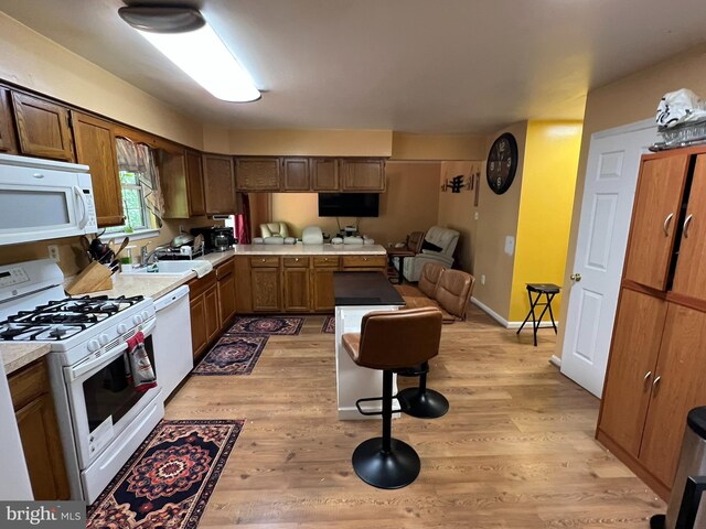 10604 Nast Dr, Cheltenham, MD 20623 - kitchen with white appliances, light countertops, light wood finished floors, a sink, and open floor plan