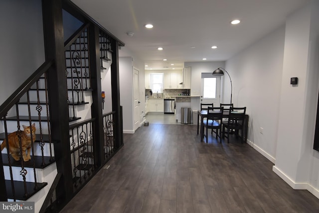 interior space with baseboards, recessed lighting, stairs, and dark wood-type flooring