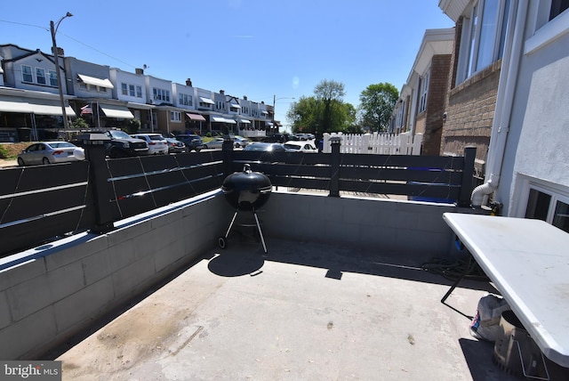 view of patio / terrace featuring a residential view and fence