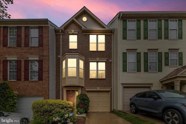 13107 Bridger Dr Unit 104, Germantown, MD 20874 - view of property featuring an attached garage, driveway, and brick siding