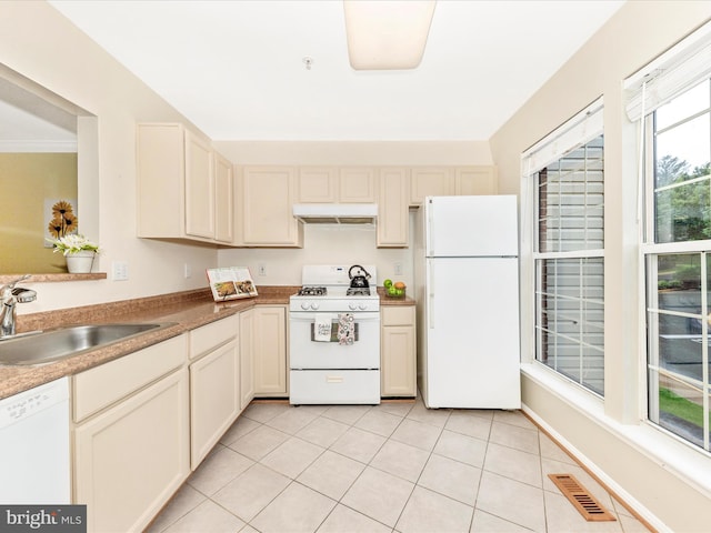 13107 Bridger Dr Unit 104, Germantown, MD 20874 - kitchen featuring white appliances, a sink, under cabinet range hood, light tile patterned flooring, and cream cabinets