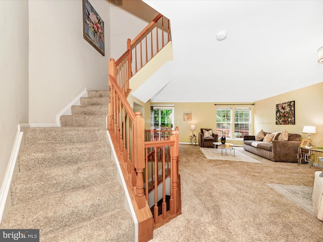 13107 Bridger Dr Unit 104, Germantown, MD 20874 - living area featuring carpet flooring, stairway, and baseboards
