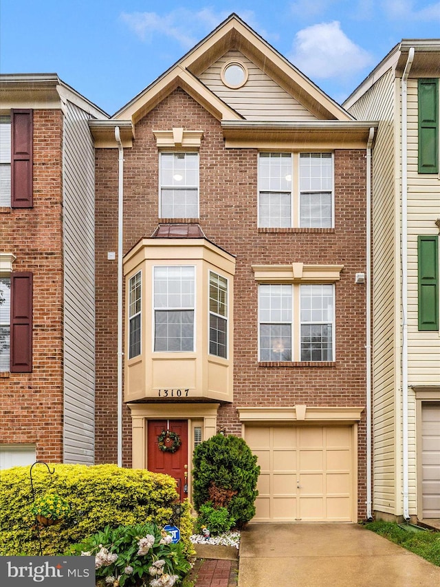 13107 Bridger Dr Unit 104, Germantown, MD 20874 - view of property with a garage, driveway, and brick siding