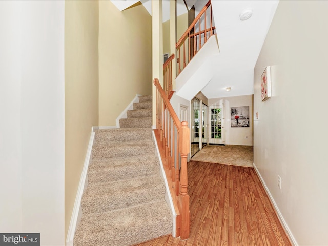 13107 Bridger Dr Unit 104, Germantown, MD 20874 - stairs with baseboards, wood finished floors, and a high ceiling