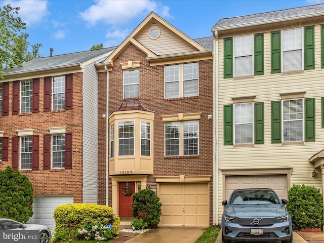 13107 Bridger Dr Unit 104, Germantown, MD 20874 - view of property with an attached garage, driveway, and brick siding