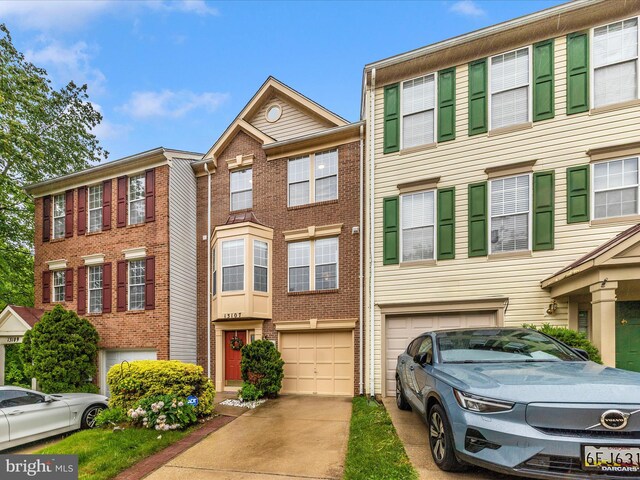 13107 Bridger Dr Unit 104, Germantown, MD 20874 - townhome / multi-family property featuring an attached garage, driveway, and brick siding