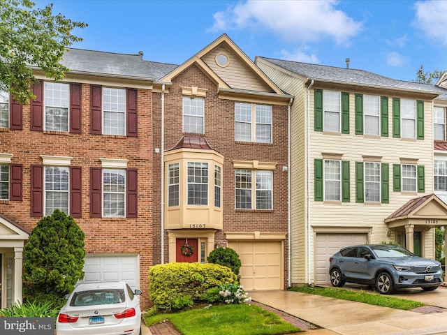 13107 Bridger Dr Unit 104, Germantown, MD 20874 - townhome / multi-family property with a garage, driveway, and brick siding