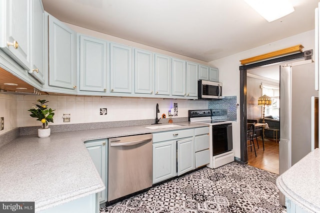 950 Wampler Ln, Westminster, MD 21158 - kitchen featuring stainless steel appliances, a sink, light countertops, backsplash, and light tile patterned flooring
