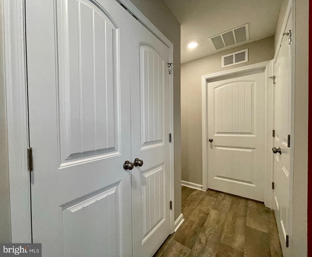 interior space with dark wood-style floors, visible vents, recessed lighting, and baseboards