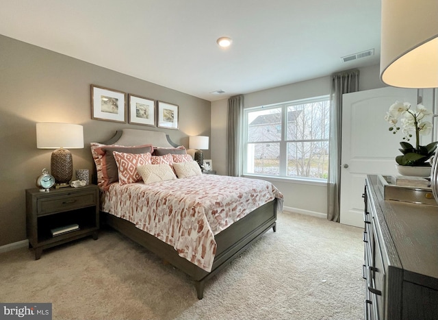 bedroom featuring light colored carpet, visible vents, and baseboards