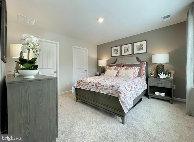 bedroom with visible vents, light colored carpet, and baseboards