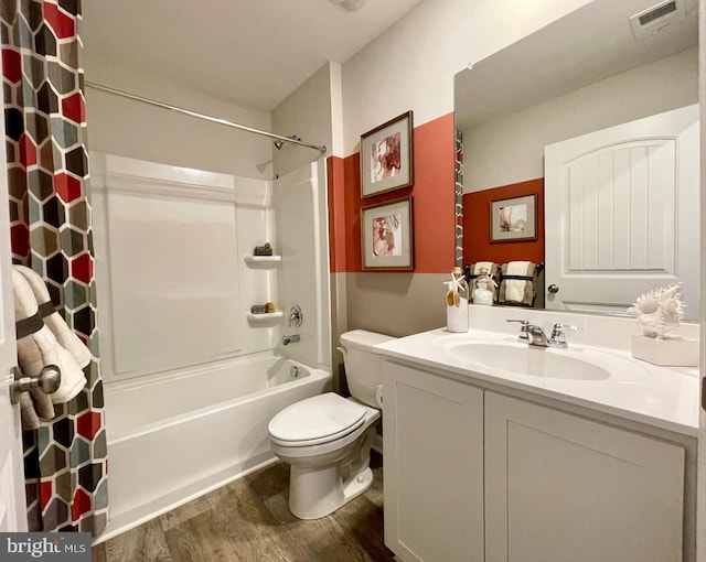 full bath with shower / bathtub combination with curtain, vanity, toilet, visible vents, and wood finished floors