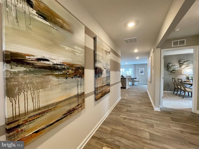 hallway with baseboards, visible vents, wood finished floors, and recessed lighting