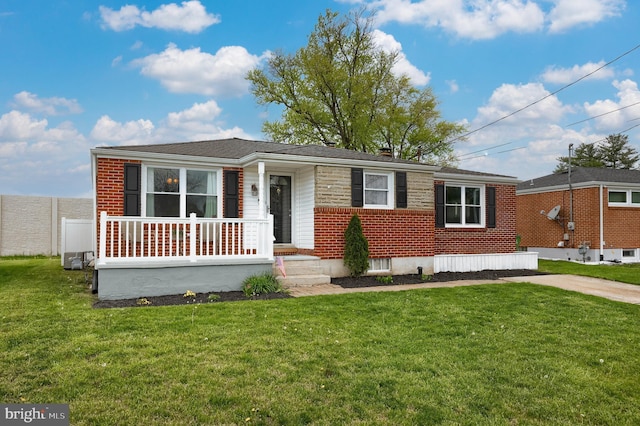 view of front of house featuring a front lawn and brick siding