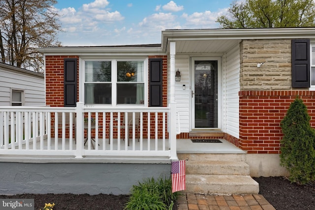 property entrance featuring brick siding
