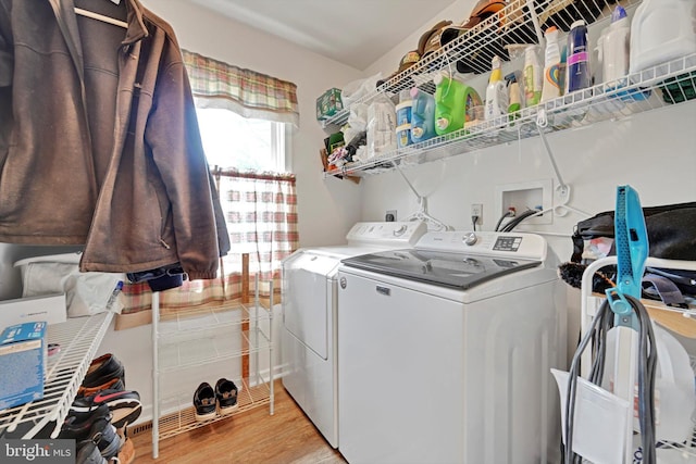laundry room with independent washer and dryer, laundry area, and light wood-style flooring