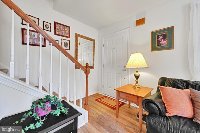 interior space with wood finished floors and stairway