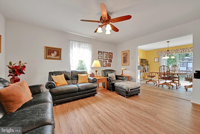 living room featuring a ceiling fan and wood finished floors