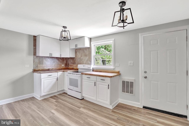 kitchen featuring backsplash, a chandelier, visible vents, and white electric range