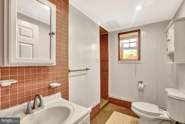 bathroom featuring a sink, tile patterned floors, and toilet