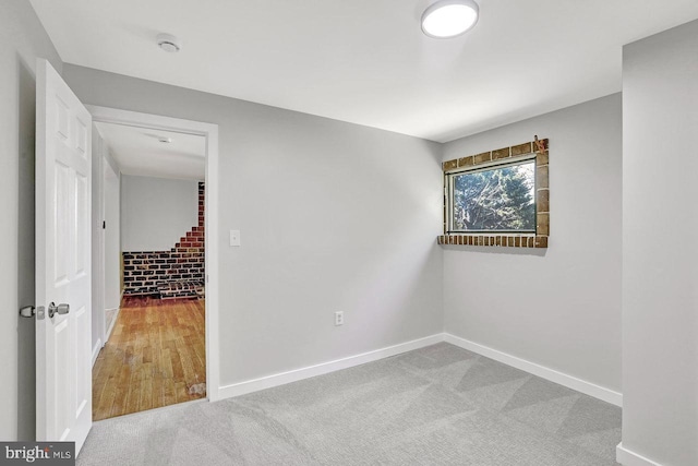 empty room featuring baseboards and carpet