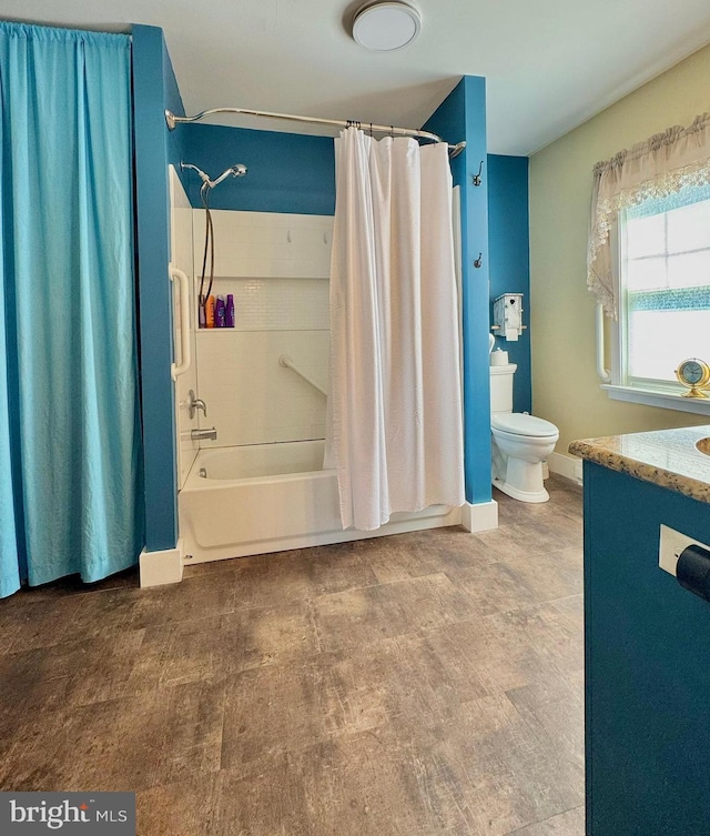 bathroom featuring shower / bath combo with shower curtain, toilet, and vanity