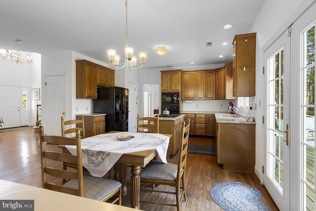 dining space with recessed lighting, dark wood-style flooring, a notable chandelier, and visible vents