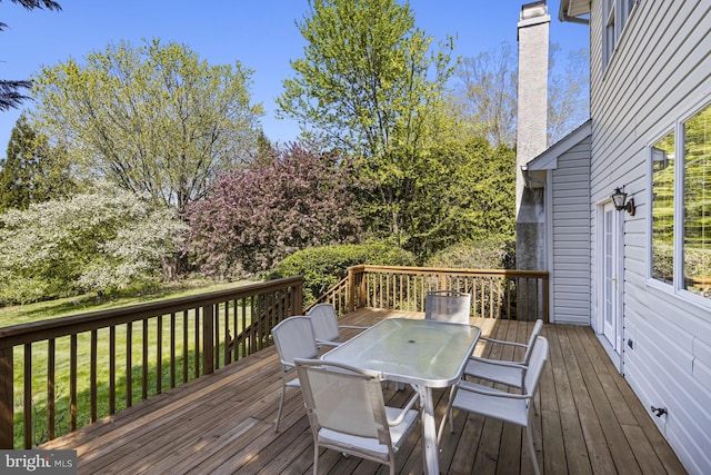 deck featuring a yard and outdoor dining space