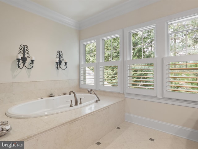 bathroom with tile patterned floors, ornamental molding, baseboards, and a garden tub