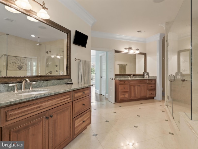 full bath featuring a sink, ornamental molding, a stall shower, and two vanities