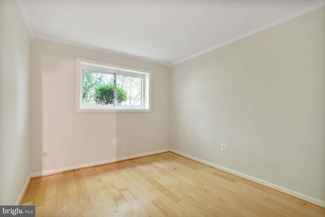 unfurnished room with wood-type flooring, baseboards, and ornamental molding