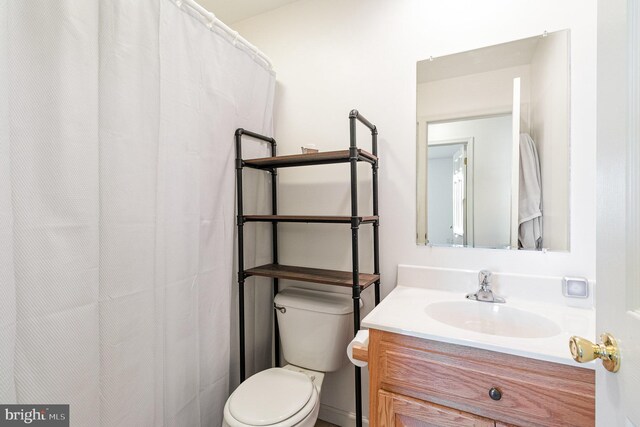 bathroom featuring toilet and vanity