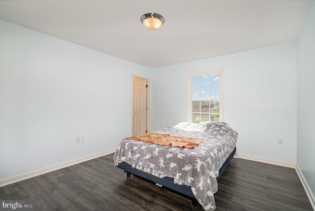 bedroom featuring dark wood finished floors and baseboards