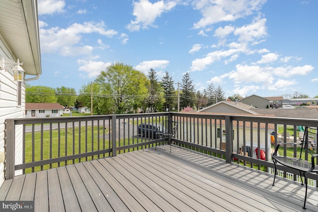 wooden deck with a lawn
