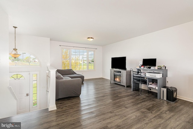 living area featuring dark wood-style floors and baseboards