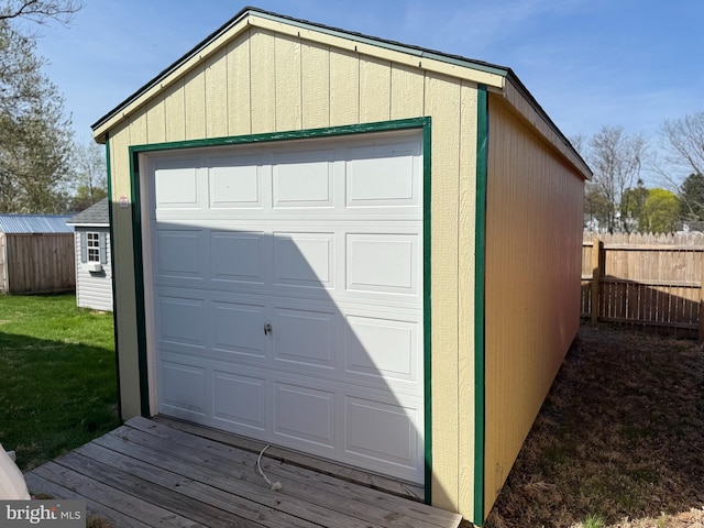 detached garage featuring fence