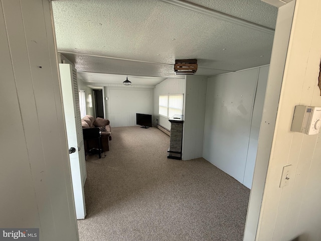hallway with carpet floors, a textured ceiling, baseboard heating, and wooden walls