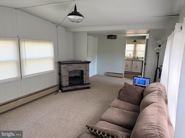 carpeted living area featuring a baseboard radiator and a fireplace
