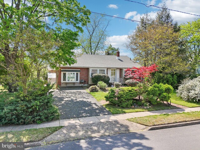 1511 Glenview Dr, Cinnaminson, NJ 08077 - view of front of house featuring a chimney, brick siding, and driveway
