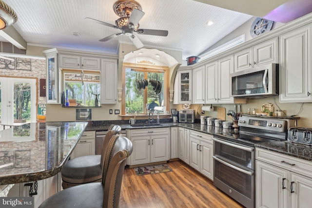 1511 Glenview Dr, Cinnaminson, NJ 08077 - kitchen featuring appliances with stainless steel finishes, a sink, ceiling fan, wood finished floors, and lofted ceiling