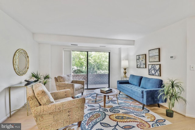 living area with light wood-type flooring and baseboards