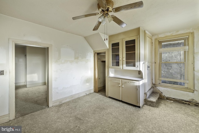 interior space featuring baseboards and a ceiling fan