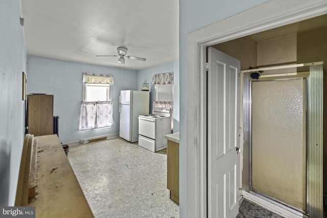 interior space featuring baseboards, a shower stall, and a ceiling fan