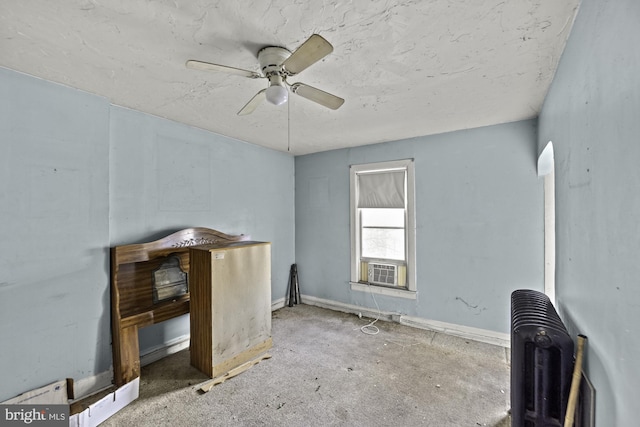 interior space featuring baseboards and a ceiling fan