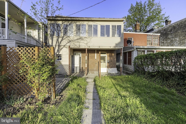 rear view of property featuring brick siding
