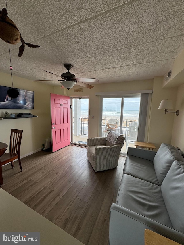 900 Kennedy Dr Unit 304, North Wildwood, NJ 08260 - living room featuring a ceiling fan, baseboards, wood finished floors, and a textured ceiling